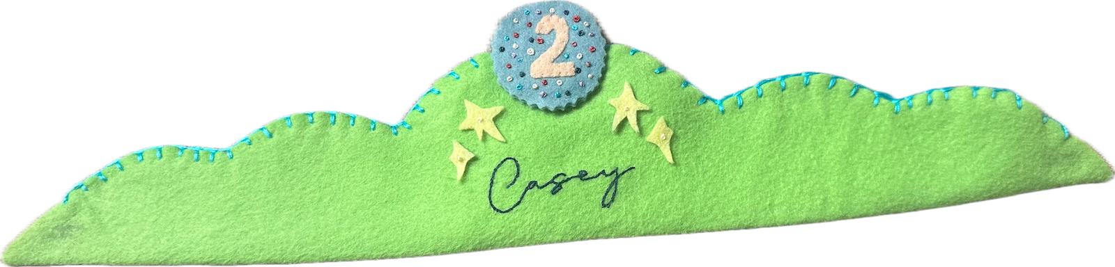 Lime-green felt crown with turquoise blanket stitching, yellow felt stars, the name Casey embroidered in navy script, and a blue sequined number 2 patch on top.